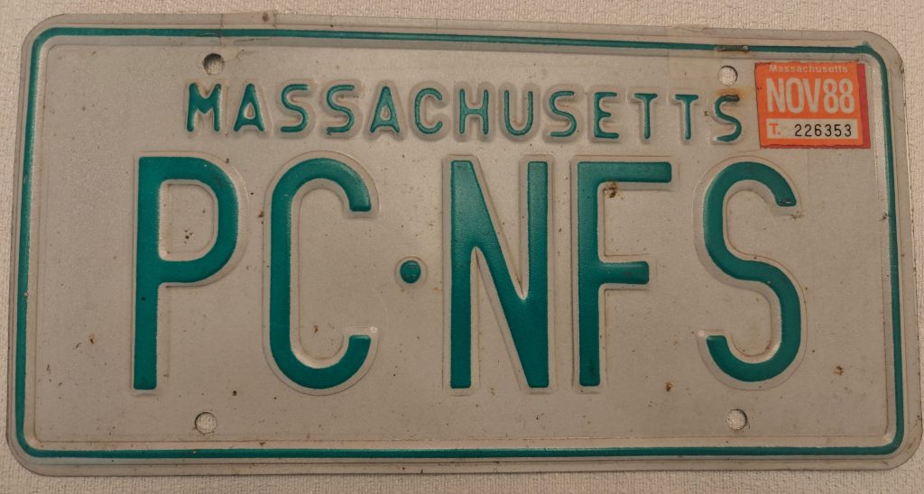 Massachusetts car license plate with the plate number "PC NFS"